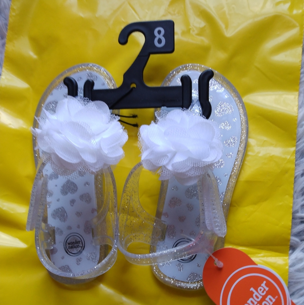 Girls Size 8 Sandals - Clear With A White Flower on Top. (New)